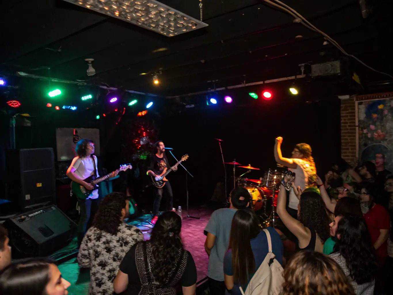 A vibrant photograph capturing a live music performance at CAVC, showcasing a local band on stage with an enthusiastic audience.